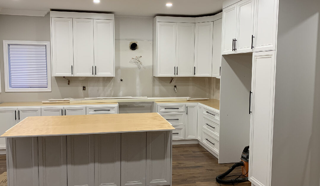 Close-up of high-quality wood cabinetry paired with a durable white quartz countertop and a classic subway tile backsplash.