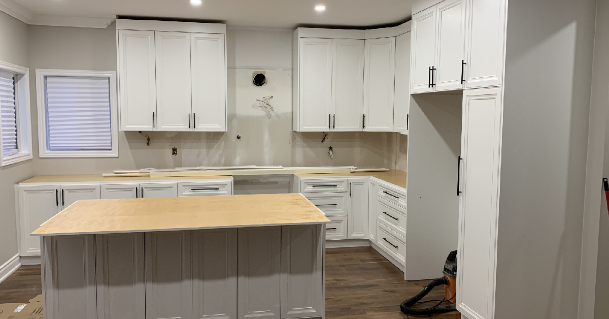 Close-up of high-quality wood cabinetry paired with a durable white quartz countertop and a classic subway tile backsplash.