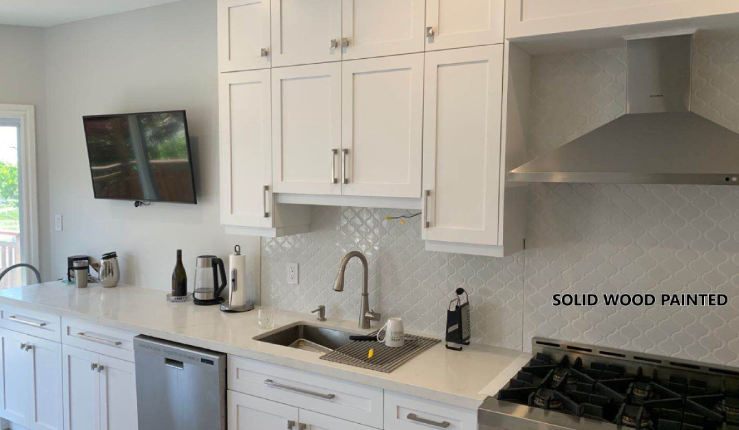 Custom white painted solid wood kitchen cabinets and millwork installed in an Oakville home by Envyland Kitchen Cabinet.