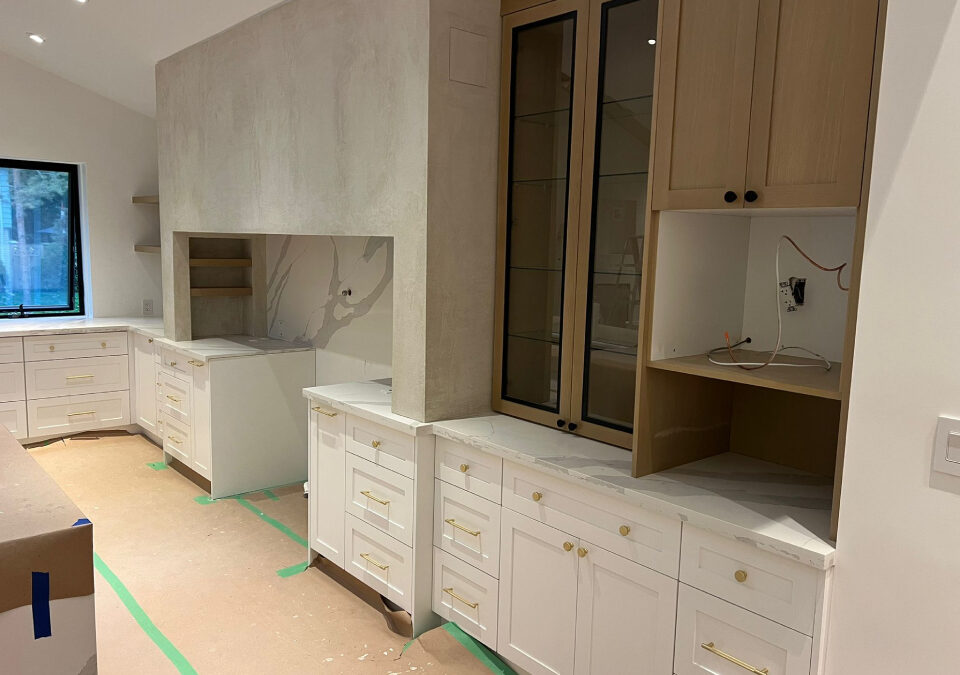 Custom white Shaker cabinets and light oak upper cabinetry with quartz countertops during an Oakville kitchen renovation by Envyland Kitchen Cabinet.