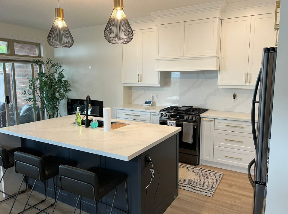 White marble-look quartz countertops and matching backsplash installed on a dark grey island and white cabinets in an Oakville kitchen renovation by Envyland Kitchen Cabinet.
